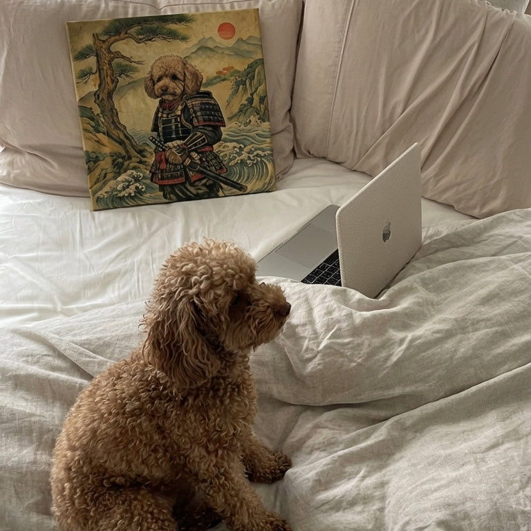 Dog sitting on a bed next to a laptop and a painting of a dog.