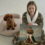 Person holding a painting of a dog with regal attire, sitting next to a real dog on a chair.