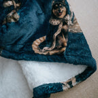 Blue blanket with dog pattern on a white surface